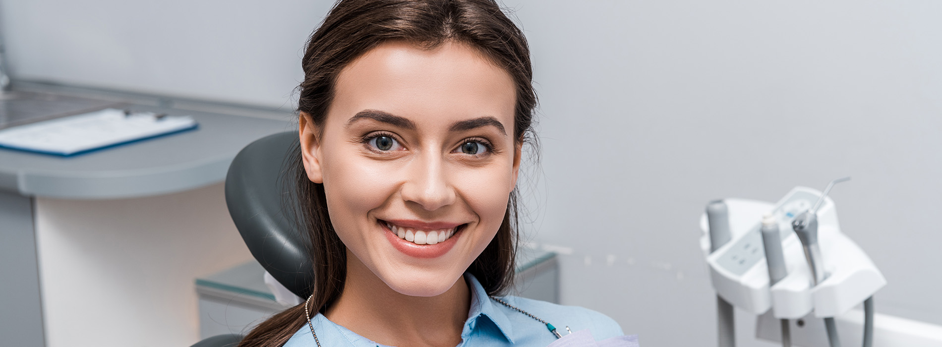 Smiling dental professional in a modern office setting.