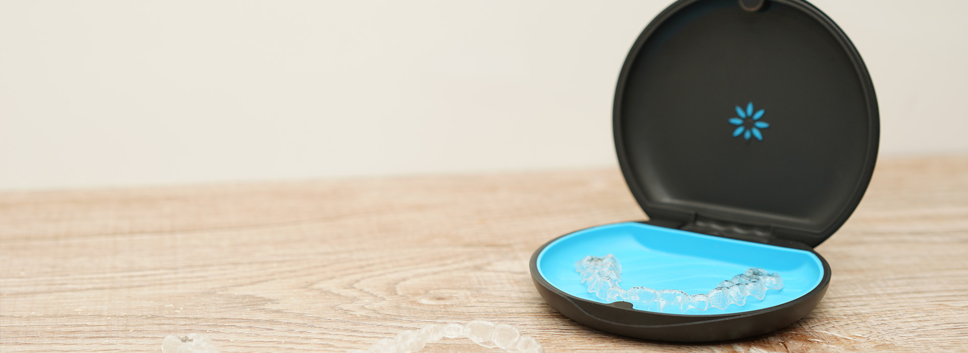 An image of a smart home device, specifically an Amazon Echo, with its lid open and a blue light illuminated inside.