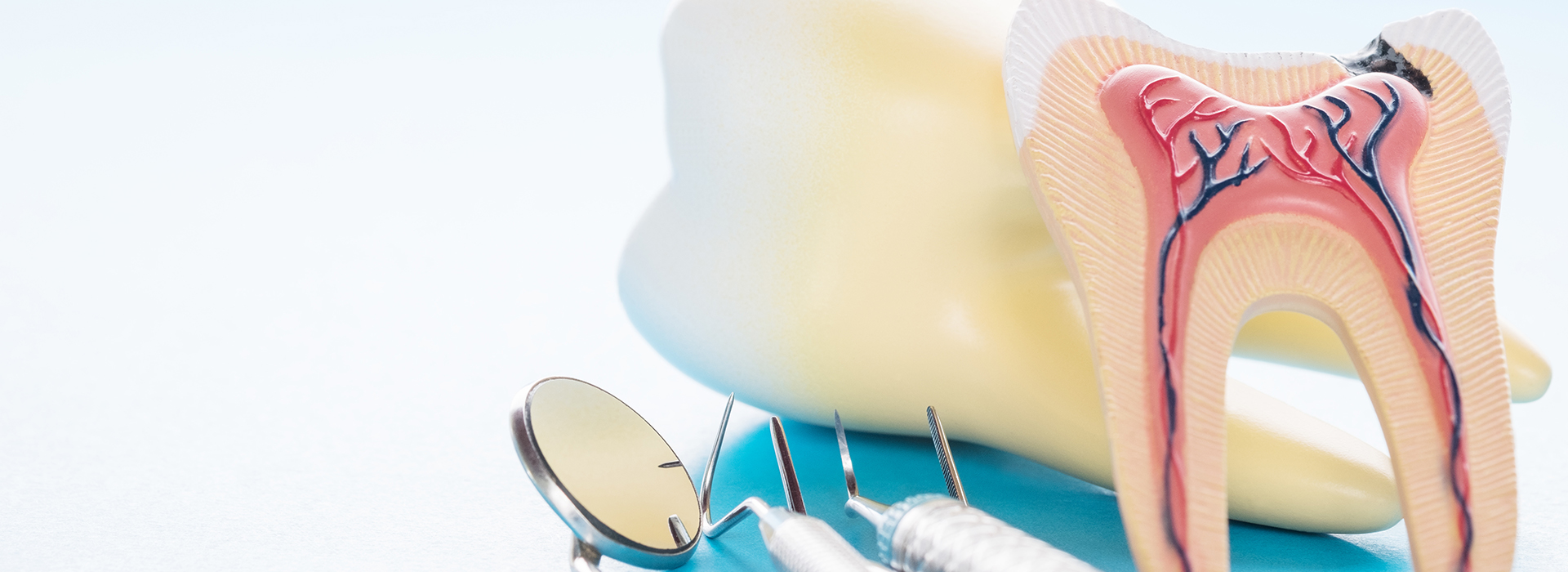 The image shows a close-up view of dental tools, including what appears to be a toothbrush and possibly other dental instruments, with a focus on oral hygiene.